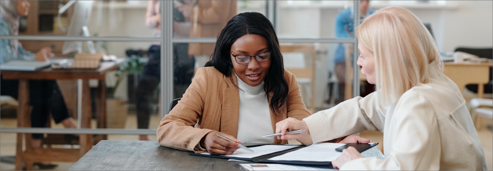 2 women reviewing paperwork in an office